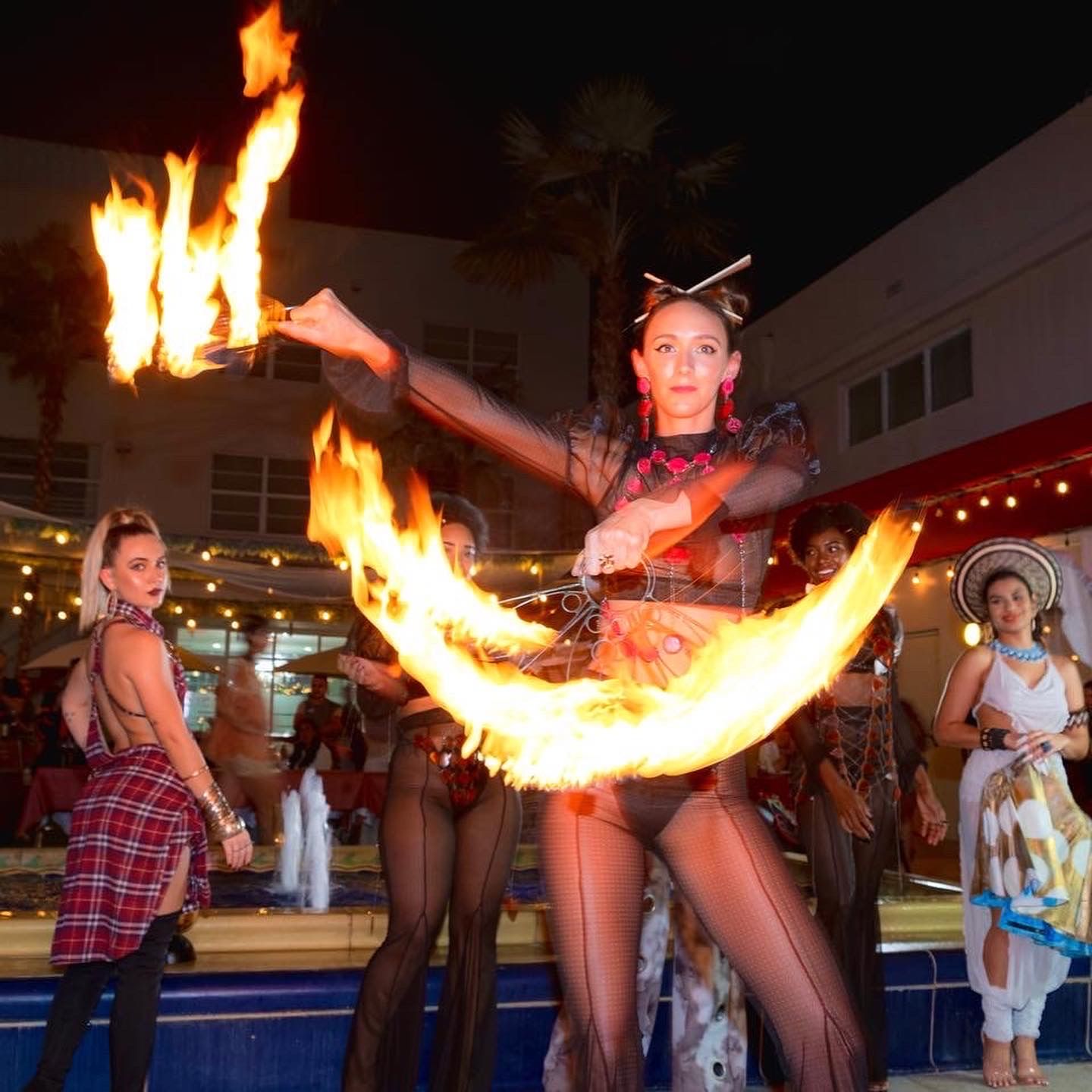 Fire fans performance by Miami fire dancer